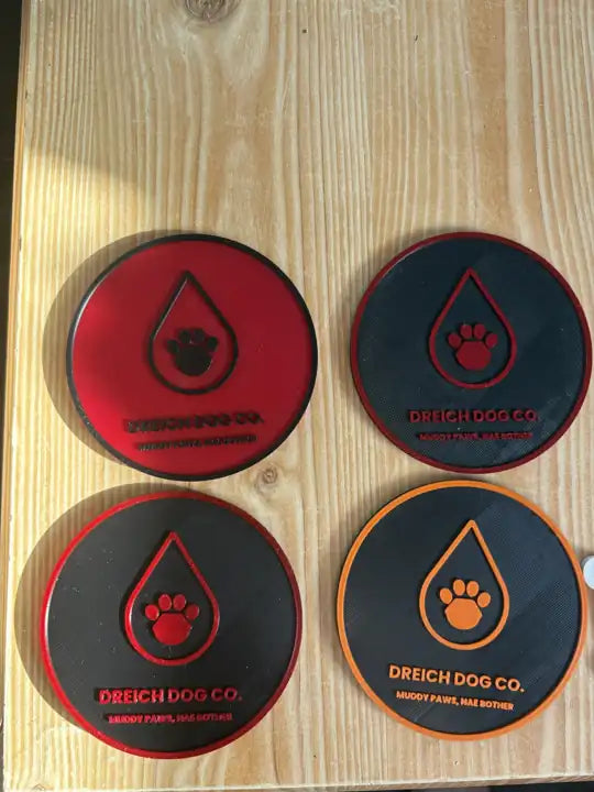 Four Muddy Paws, Nae Bother coasters printed in red, black and orange